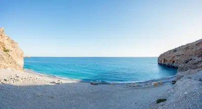 a group of people on a beach near the ocean at Ilingas Mare in Khóra Sfakíon