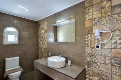 a bathroom with a sink and a toilet at Ilingas Mare in Khóra Sfakíon