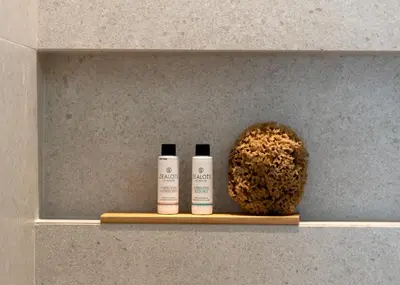 a shelf with two bottles of sunscreen and a coconut at Athina Luxury Villa, with Pool & Walk to the Beach, By ThinkVilla in Chania Town