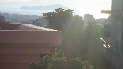 a view of a city from a building with the sun shining at Chania City Apartments in Chania Town