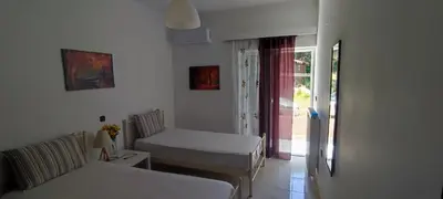 a white room with two beds and a window at Chania City Apartments in Chania Town