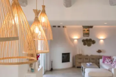 a living room with three lights hanging from the ceiling at Villa Everlong in Vamos