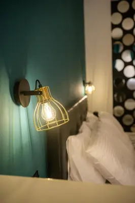 a lamp on the side of a bed in a room at welcome Dream home in Chania Town