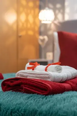 a pile of towels sitting on top of a bed at welcome Dream home in Chania Town