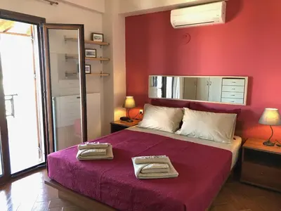 a bedroom with a bed with two towels on it at Zafeiria's Suite in Vamos