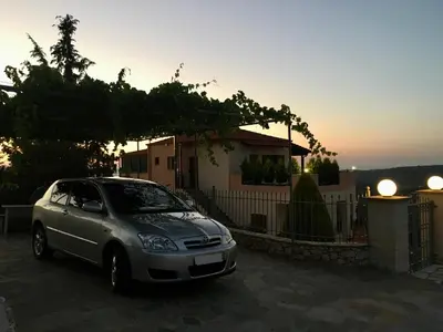 a silver car parked in front of a house at Zafeiria's Suite in Vamos