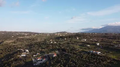 an aerial view of a city with trees and mountains at Zafeiria's Suite in Vamos