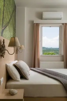 a bedroom with a large bed with a window at Majestic Villa in Chania Town