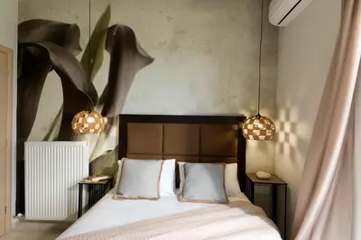 a bedroom with a bed with two night stands and two lights at Majestic Villa in Chania Town