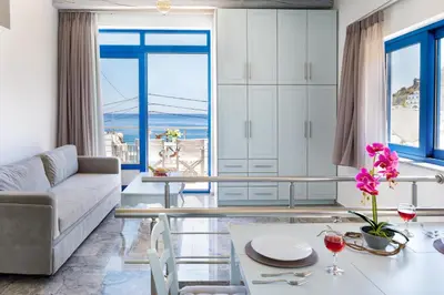 a living room with a view of the ocean at Plori - Molos Apartments in Loutro