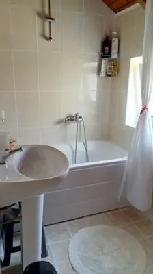 a white bathroom with a sink and a tub at Roof-Garden Apartment in Chania Town