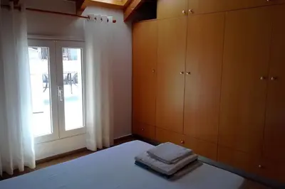 a bedroom with a bed with a window and towels at Roof-Garden Apartment in Chania Town