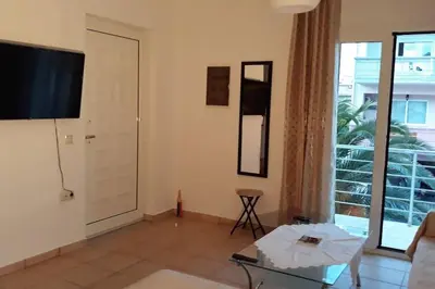 a living room with a flat screen tv on the wall at Roof-Garden Apartment in Chania Town