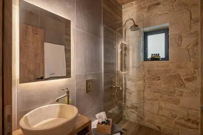a bathroom with a sink and a shower at Villa Magnolia in Ayiá