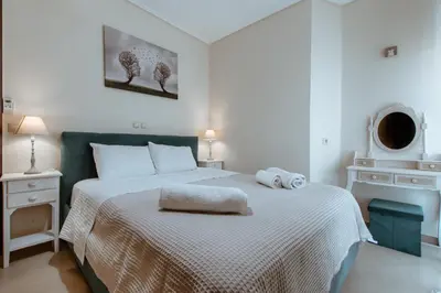 a bedroom with a bed with two towels on it at Lazaretta apartment in Chania Town