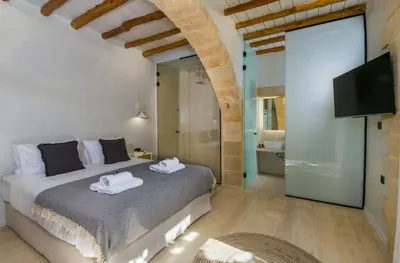 a bedroom with a bed with towels on it at Casa di Grimpili in Kolymvari
