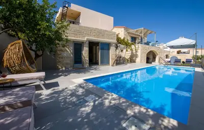 a swimming pool in front of a house at Casa di Grimpili in Kolymvari