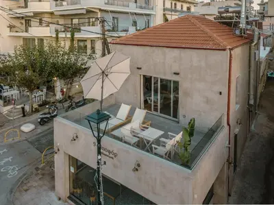 a building with a umbrella on top of it at Fragios Beach House in Chania Town
