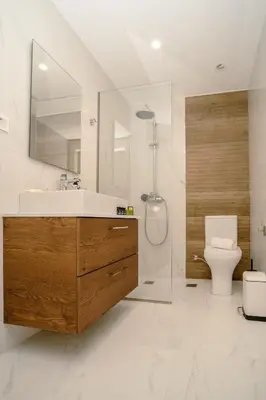 a bathroom with a sink and a shower and a toilet at Fragios Beach House in Chania Town