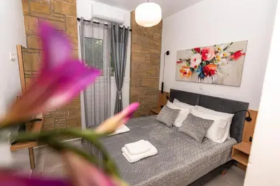 a small bedroom with a bed and a flower at Rikanthos Stone Sea View Apartment Ι in Falelianá