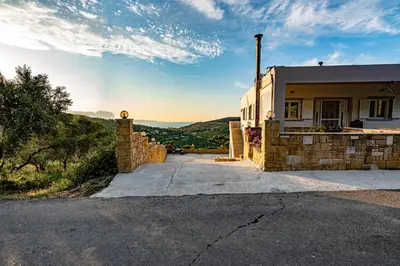 a house on the side of a hill at Rikanthos Stone Sea View Apartment Ι in Falelianá