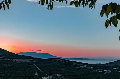 a view of the sunset from a hillside at Rikanthos Stone Sea View Apartment Ι in Falelianá