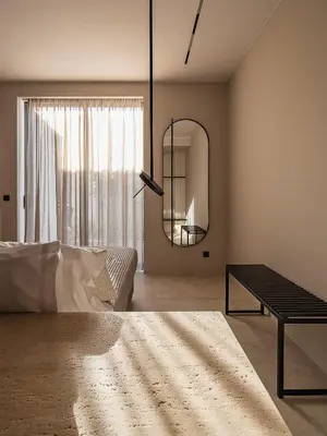 a bedroom with a mirror and a bed and a table at Villas Phos and Kallos in Kissamos