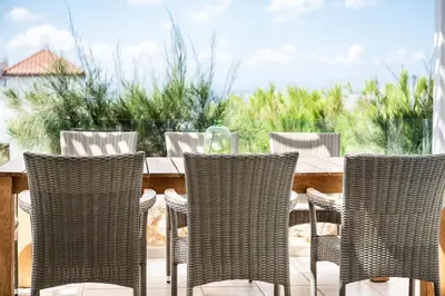 a group of chairs and a table on a patio at VILLA AMANTELLA in Stavros