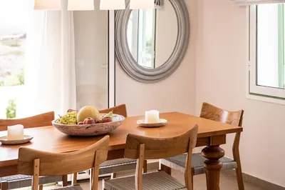 a dining room table with a bowl of fruit on it at VILLA AMANTELLA in Stavros