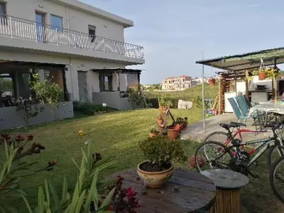 a house with two bikes parked in a yard at SEA BREEZE APARTMENTS in Kolymvari