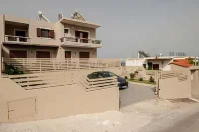 a car parked in the driveway of a house at Thyme Sea View Apartments by 8essentially in Souda