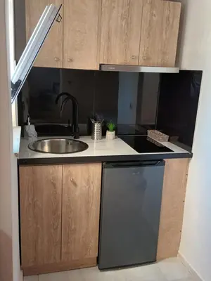 a kitchen with a sink and a stove at Secret Garden Hotel in Maleme
