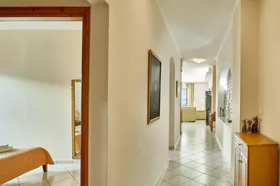 a hallway with white walls and tile floors at Sea View House in Kissamos