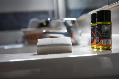a roll of paper towels and a bottle of oil on a counter at Sea View House in Kissamos