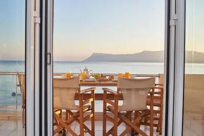 a dining room with a view of the ocean at Sea View House in Kissamos
