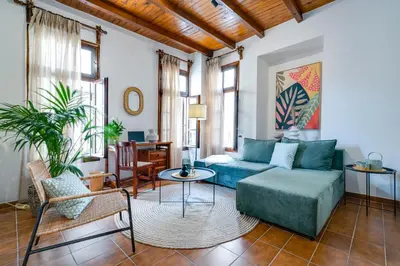 a living room with a couch and a table at Monk Rooms in Chania Town