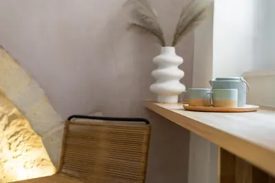 a shelf with two cups and a vase on it at Monk Rooms in Chania Town