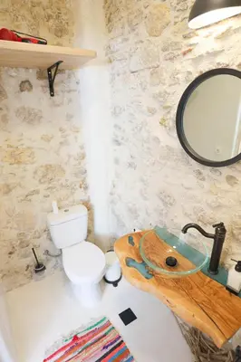 a bathroom with a toilet and a sink with a mirror at Ravi Boutique Home - 1 minute walk from beach in Kalyves