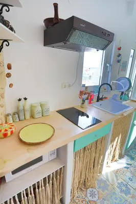 a kitchen with a counter with a sink and a stove at Ravi Boutique Home - 1 minute walk from beach in Kalyves