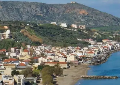 a town on a hill next to a body of water at Lemon Tree House in Kalyves