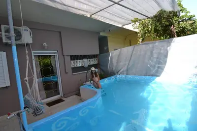 a person in an indoor swimming pool with a water slide at Paradise House with Private Pool in Kissamos
