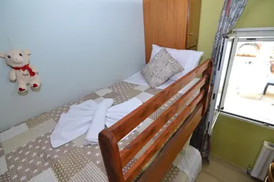 a bed with a teddy bear sitting on top of it at Paradise House with Private Pool in Kissamos