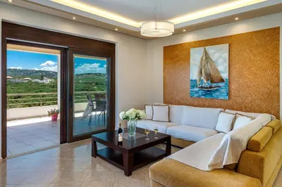 a living room with a couch and a table at Villa Alexandra in Kolymvari