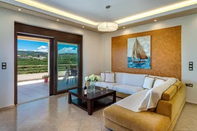 a living room with a couch and a table at Villa Alexandra in Kolymvari
