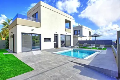 a white house with a swimming pool in the yard at Villa Maripol by PosarelliVillas in Galatás