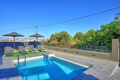 a swimming pool on the roof of a house at Villa Maripol by PosarelliVillas in Galatás