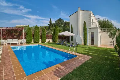 a villa with a swimming pool in a yard at Villa Politini by PosarelliVillas in Vryses