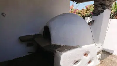 an oven in the side of a building at Afrodite's House-Restaurated Oil Factory in Ayiá