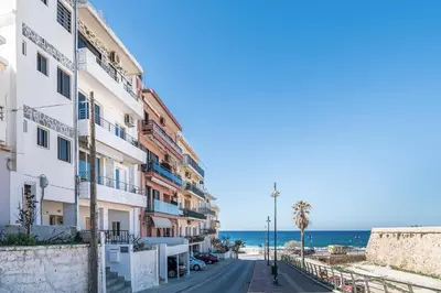 a street in front of a building with the ocean at West City Apartment in Chania Town