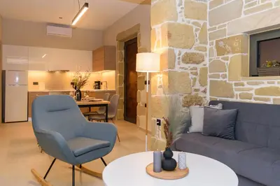 a living room with a couch and a table at Effrosini Panorama View in Nopíyia